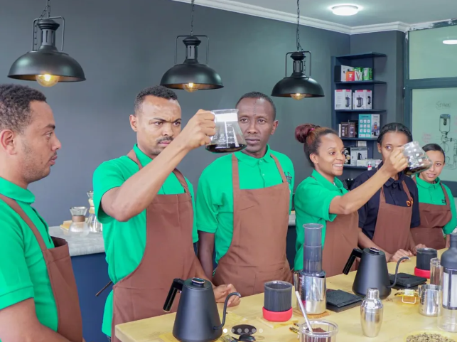 Kemesha Academy students examining coffee
